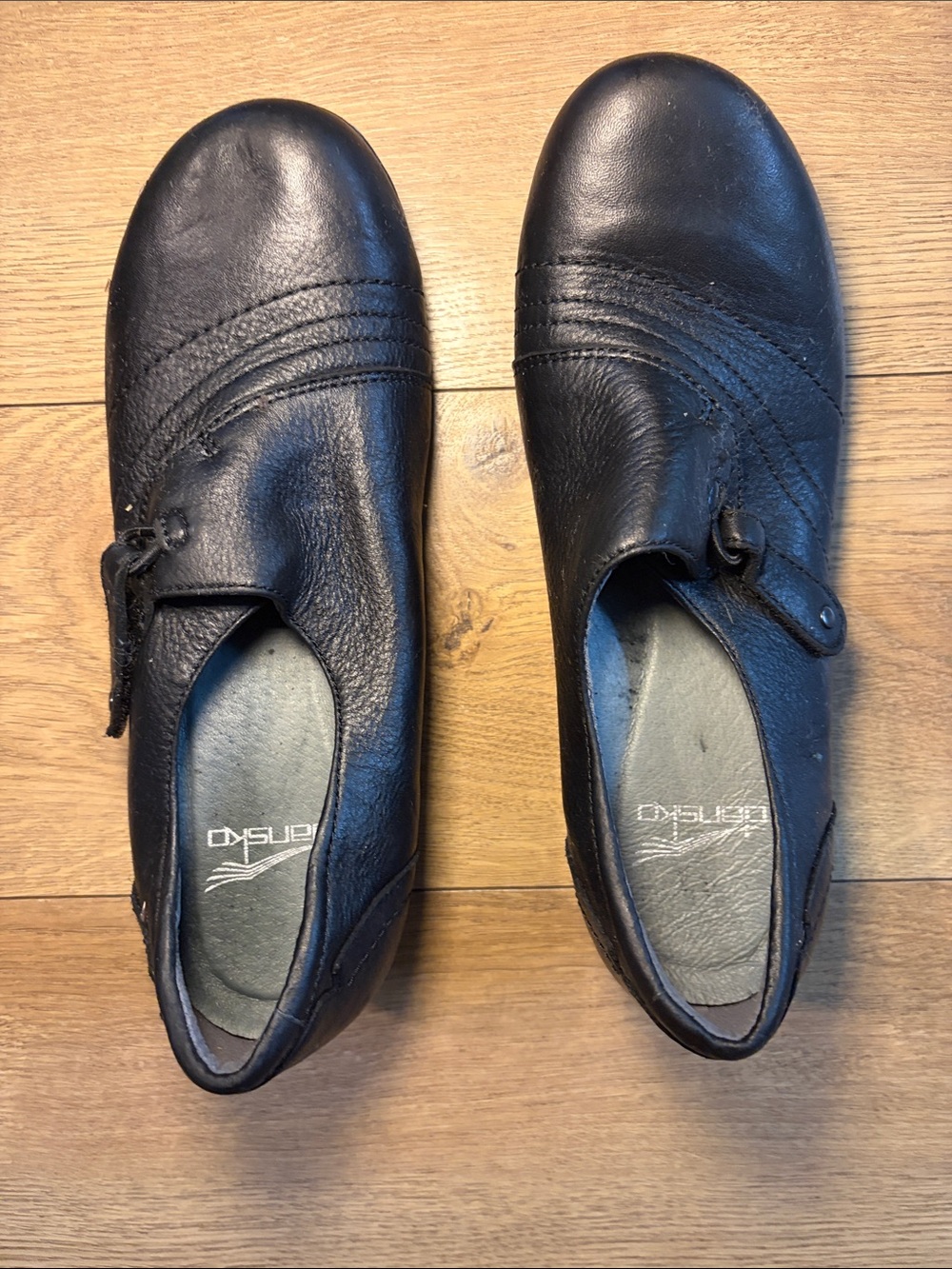 Dansko Black Leather Slip-On Loafers with Side Tab Detail